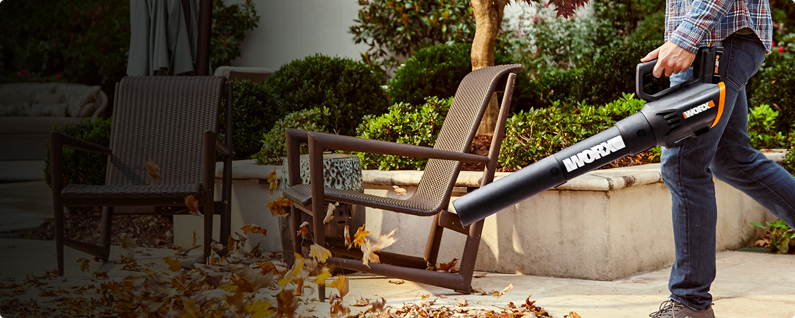 WORX WG547 handheld blower component shown in outdoor leaf cleanup; not the full WG929 combo.
